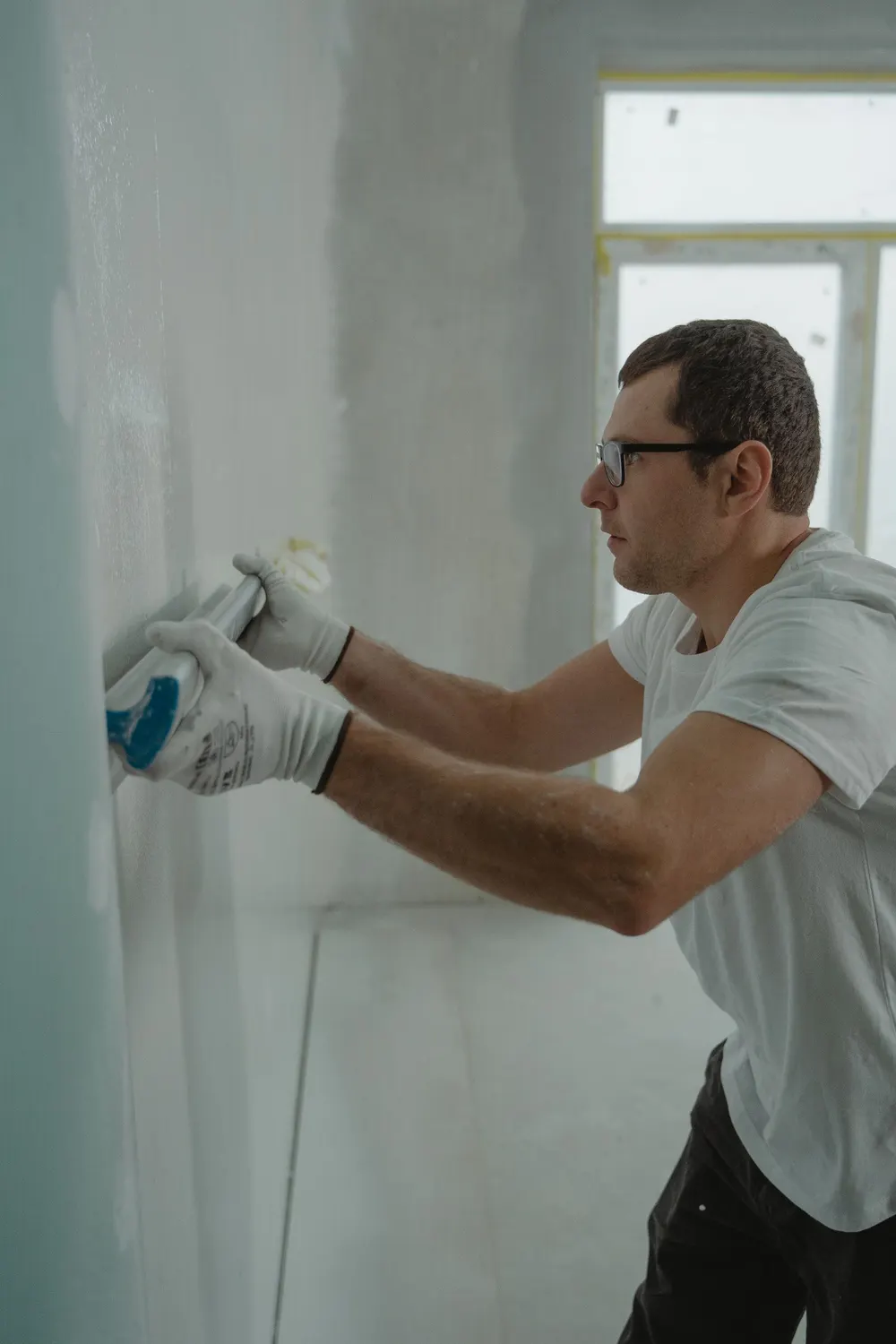 Finisher smoothing a drywall joint with a knife